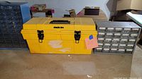 Yellow Stack-On toolbox with handle and black latches, closed, empty