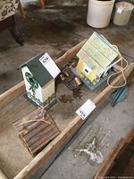 Full view of bird houses and metal wind chimes together on wooden tray