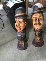 Front view of the pair of Laurel and Hardy resin figures, showing detailed facial features and clothing.