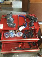 Tool box top with electrical sander, heat gun, hacksaw, screwdrivers, and hardware boxes