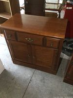 Full front view of the small Vilas wood buffet showing drawers, cabinet doors and minor surface wear.