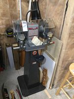 Full assembled view of bench grinder on pedestal with light