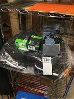 Photo showing a pair of green and black Evo 20-inch tire tube boxes and black Axiom carrier bags wrapped in plastic on metal shelf.