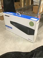 Boxed Bose Solo 15 Series II soundbar displayed on metal shelving