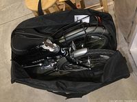 Folded bicycle inside black Avenir carrying bag