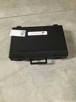 Closed black plastic carrying case with Lantek logo