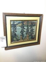 Framed print of autumn river scene with pine trees by Lauren Harris, titled Montreal River