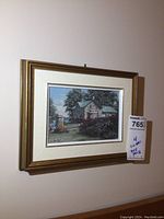 Framed print titled "The Garden Wall" showing a stone house with trees and garden, signed by Keirstead, in a wood and fabric mat frame.