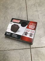 Photo of the Coleman barbecue cover in original packaging showing brand and size details.