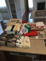 Overall view of two throws and assorted table linens on countertop