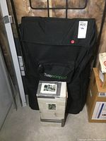 Photo of a black telescopic ladder bag with 'Telescopics' branding and a box placed in front of it.