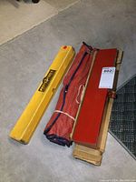 Three tool sets side by side: yellow Proto Tools torque wrench box, red canvas wrench roll, red metal case
