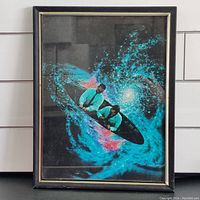 Front view of framed collage art featuring two men in teal shirts in a black spaceship surrounded by blue and pink cosmic swirls.