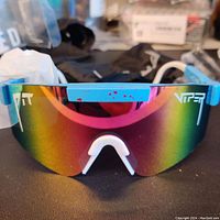 Front view of Pit Viper polarized sunglasses with rainbow lens and blue frame