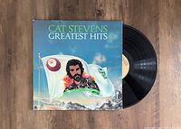 Vinyl record with original album cover placed partially out of the sleeve, showing title and cover artwork