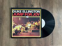 Vinyl record and the album cover for Duke Ellington Jump For Joy, showing the front cover design and the black vinyl disc partly slid out.
