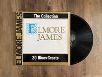 Front cover of Elmore James '20 Blues Greats' vinyl album with record partially out of the sleeve.