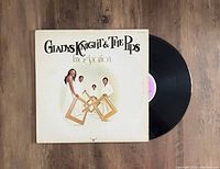 Front cover of Gladys Knight & The Pips LP titled 'Imagination' with vinyl record partially visible.