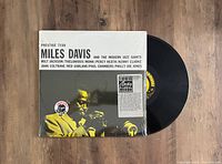 Miles Davis and The Modern Jazz Giants vinyl record with original cover showing Miles Davis playing trumpet, Prestige 7150 label visible on the record.