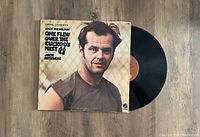 View of the vinyl LP album for One Flew Over The Cuckoo's Nest, showing cover and part of record.
