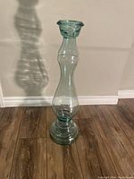 Front view of the 29 inch tall heavy glass decorative vase showing its tall slender form with bulbous mid section and flared rim.