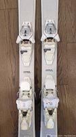 Top view of the skis focusing on the Grip Walk bindings, showing the white bindings with locking mechanisms and adjustment features.