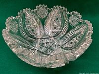 Top view of the cut glass crystal bowl showing detailed internal floral and starburst patterns with scalloped rim.