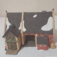 Front view of Dept 56 Butter Tub Barn figurine showing detailed doors and snow on roof