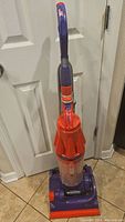 Front view of the Dyson DC07 vacuum cleaner showing handle, cyclone section, and base.