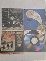 Eight vintage vinyl records visible with some album covers readable, showing condition and titles.