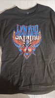 Front view of the black Lynyrd Skynyrd T-shirt with colorful band logo and winged skull design.