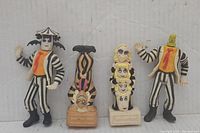Four vintage Beetlejuice toys displayed side by side on white background, showing front view details and colors