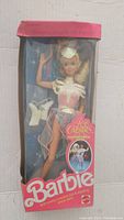 Full view of the Barbie doll in original Ice Capades box, showing the doll dressed in ice skating outfit with ribbons, hat, and ice skates visible.