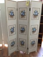 Full view of the 3 panel folding screen, showing all floral panels and the ivory color with gold trim.