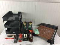 Photo showing the entire set of used office supplies including metal paper sorter, canceled check file box, pencils, tape dispensers, staplers, staples, and X-ACTO paper cutter.