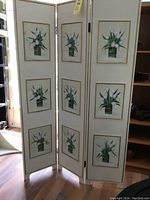 Full view of the 3-panel ivory folding screen with tulip paintings and gold trim.