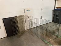 Photo showing the dog crate panels folded and the plastic base tray behind them
