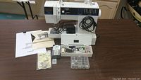 Full view of Singer Limited Edition sewing machine with manuals and accessories on table