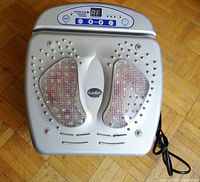 Top view of silver foot massager showing textured foot pads and control panel with iComfort logo.