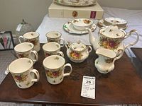 Full set on table showing teapot, sugar bowl, creamer, and six mugs