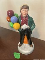 Front view of Royal Doulton HN3924 Balloon Boy figurine holding colorful balloons.