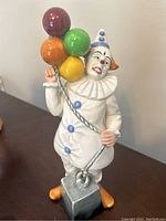 Front view of Royal Doulton Balloon Clown figurine showing colorful balloons and detailed face.