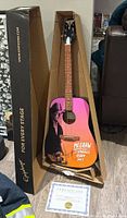 Full view of guitar in original Epiphone branded shipping box with Certificate of Authenticity at base