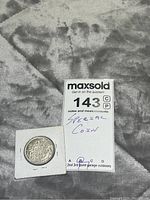 The coin displayed alongside a MaxSold tag specifying 'Special Coin' with auction lot number 143.