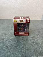 Front of unopened Funko Pop Minis box showing Magneto figure inside with number 15 and Marvel branding.