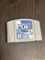 Grey Nintendo 64 cartridge with Pilotwings 64 label on front, some wear on label and cartridge surface.