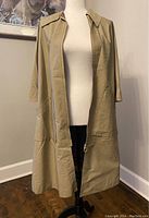 Front view of vintage 1960s Croydon cream poncho cape coat with collar, zipper, and pockets visible.