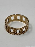 Side angle showing the ring's square cutout design and textured finish.