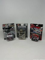 Front view of three sealed Racing Champions 1:64 scale die cast cars, showing packaging and car detail.