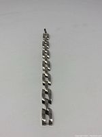 Full length view of the heavy link silver bracelet showing the stacked links and clasp.